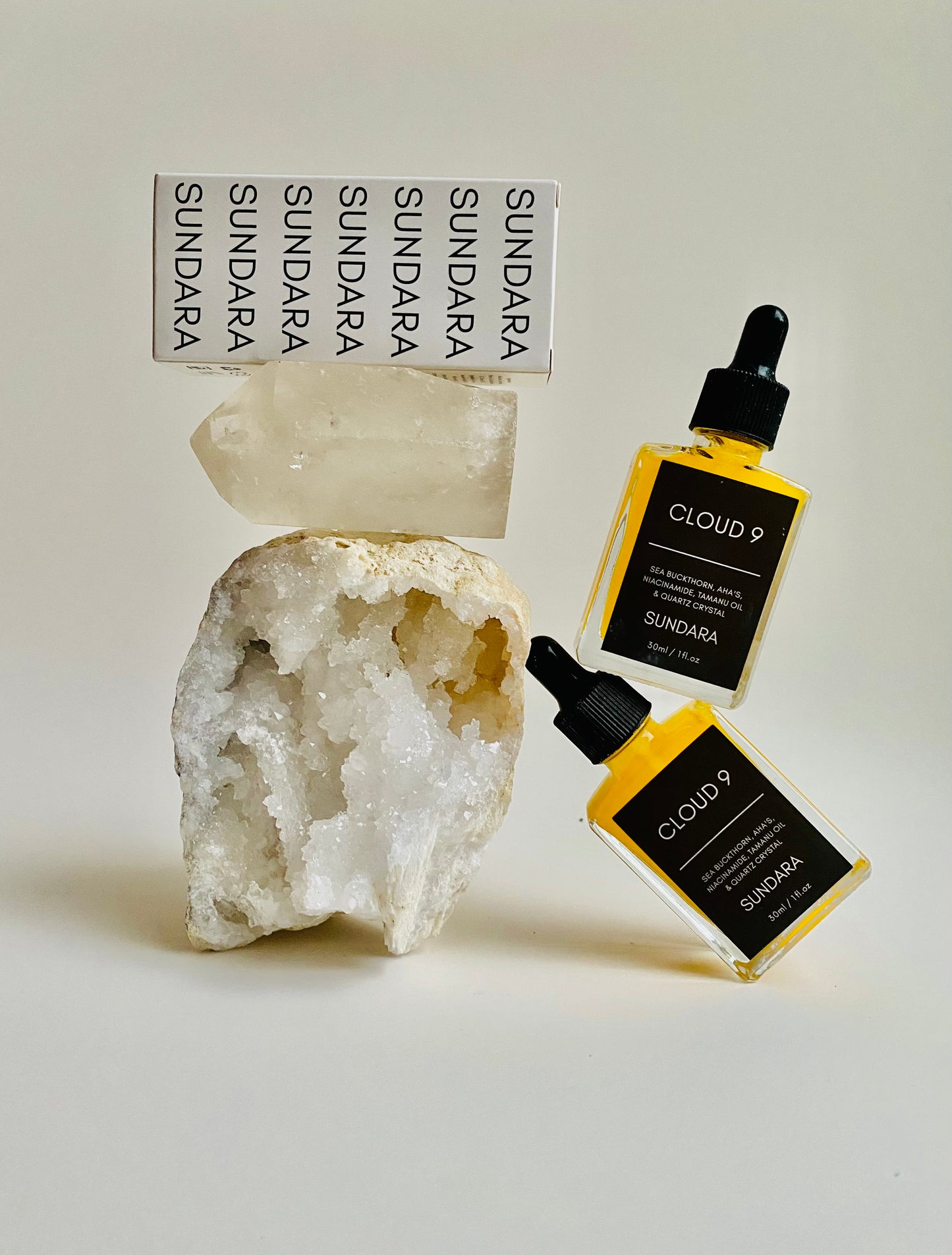 Soul of Sundara Blue Nova and Cloud 9 quartz crystal skincare serum combo pack  balancing on a quartz crystal
