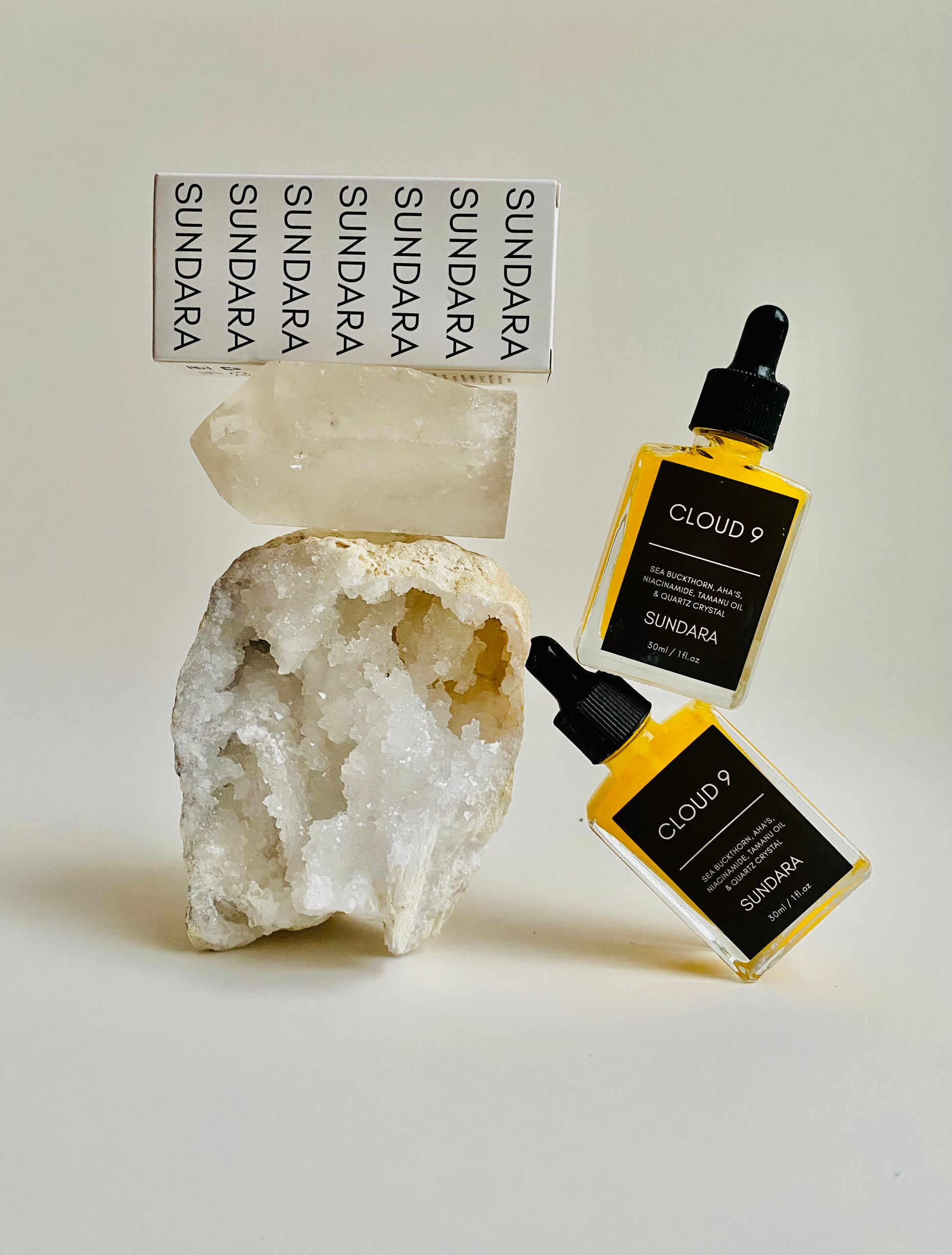 Soul of Sundara Blue Nova and Cloud 9 quartz crystal skincare serum combo pack  balancing on a quartz crystal