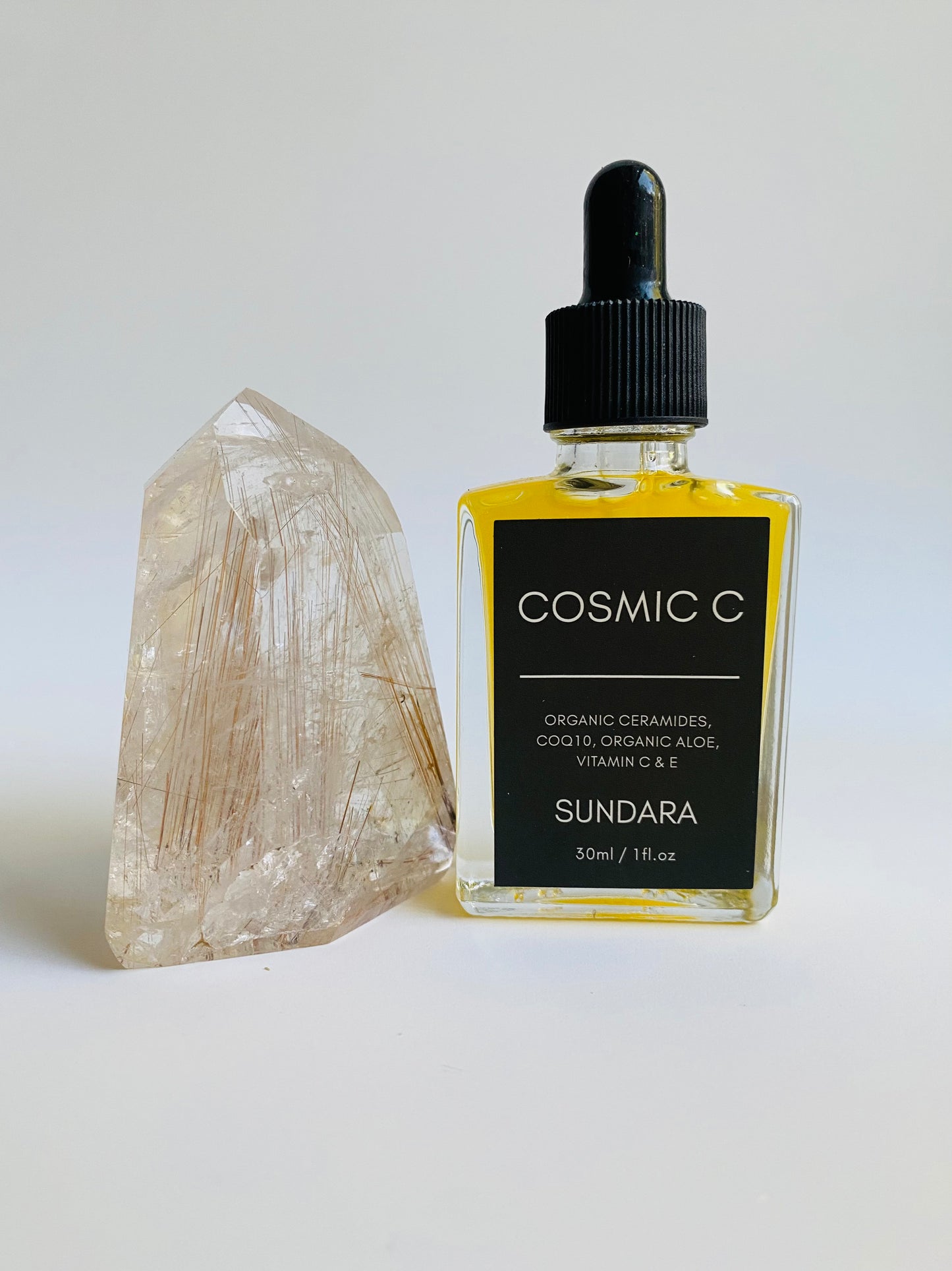 Soul of Sundara Cosmic C Serum on Quartz Crystal. Organic skincare, Ceramides, CoQ10, Organic Aloe, Vitamin C, Vitamin E brightening serum for acne and hyperpigmentation. 