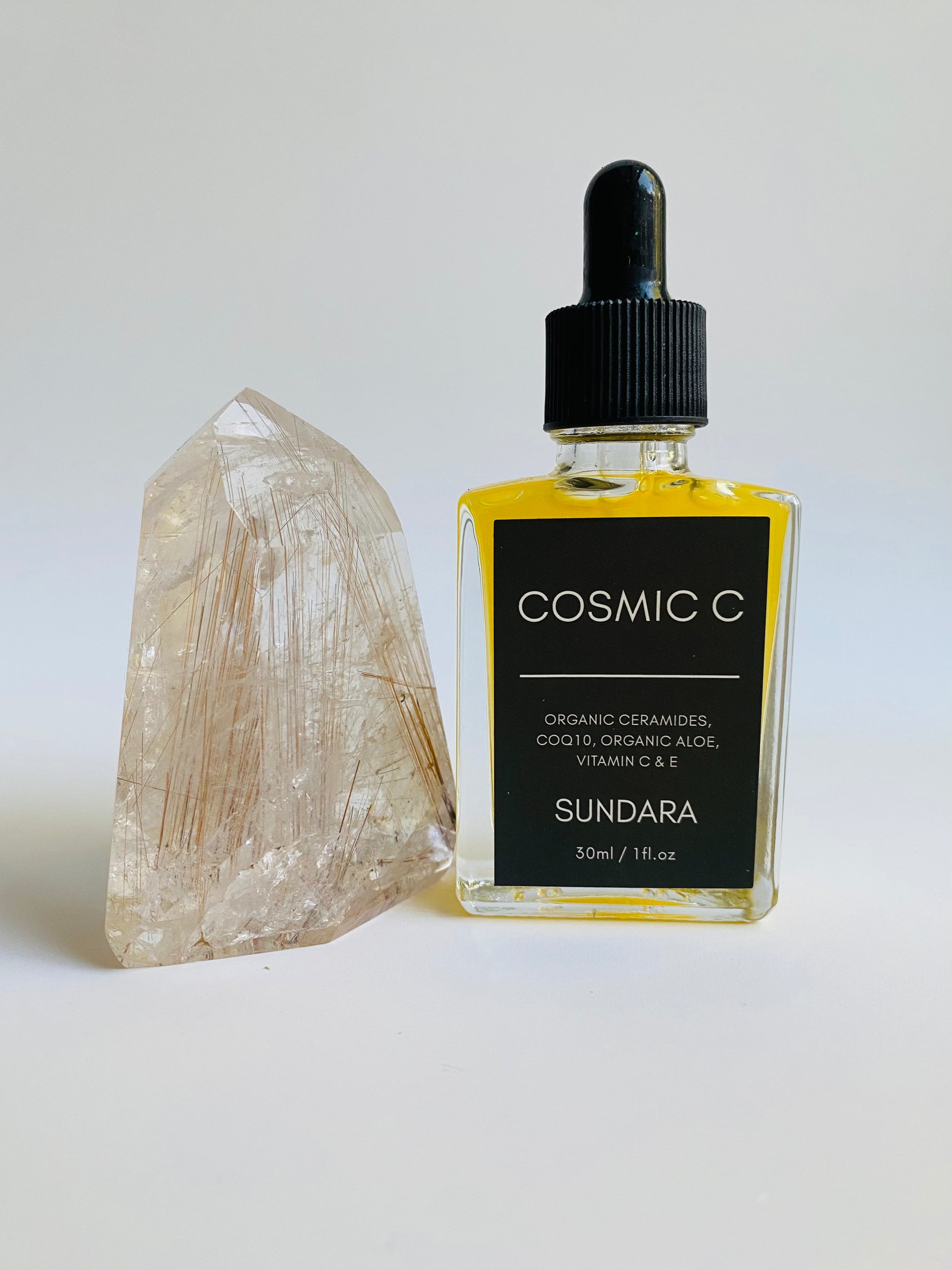Soul of Sundara Cosmic C Serum on Quartz Crystal. Organic skincare, Ceramides, CoQ10, Organic Aloe, Vitamin C, Vitamin E brightening serum for acne and hyperpigmentation. 