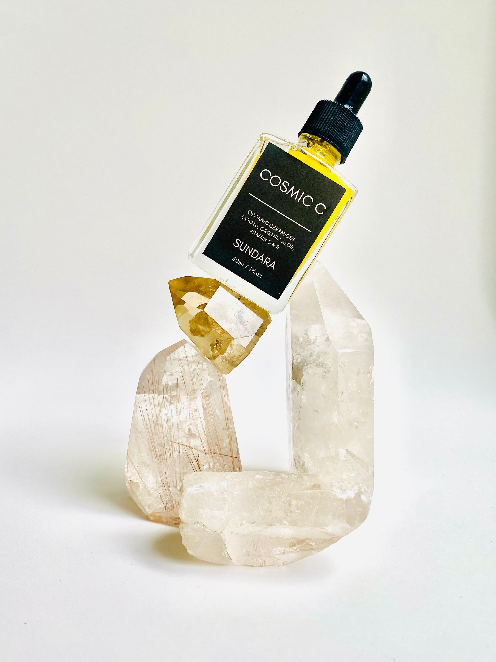 Soul of Sundara Cosmic C Serum on Quartz Crystal. Organic skincare, Ceramides, CoQ10, Organic Aloe, Vitamin C, Vitamin E brightening serum for acne and hyperpigmentation. 