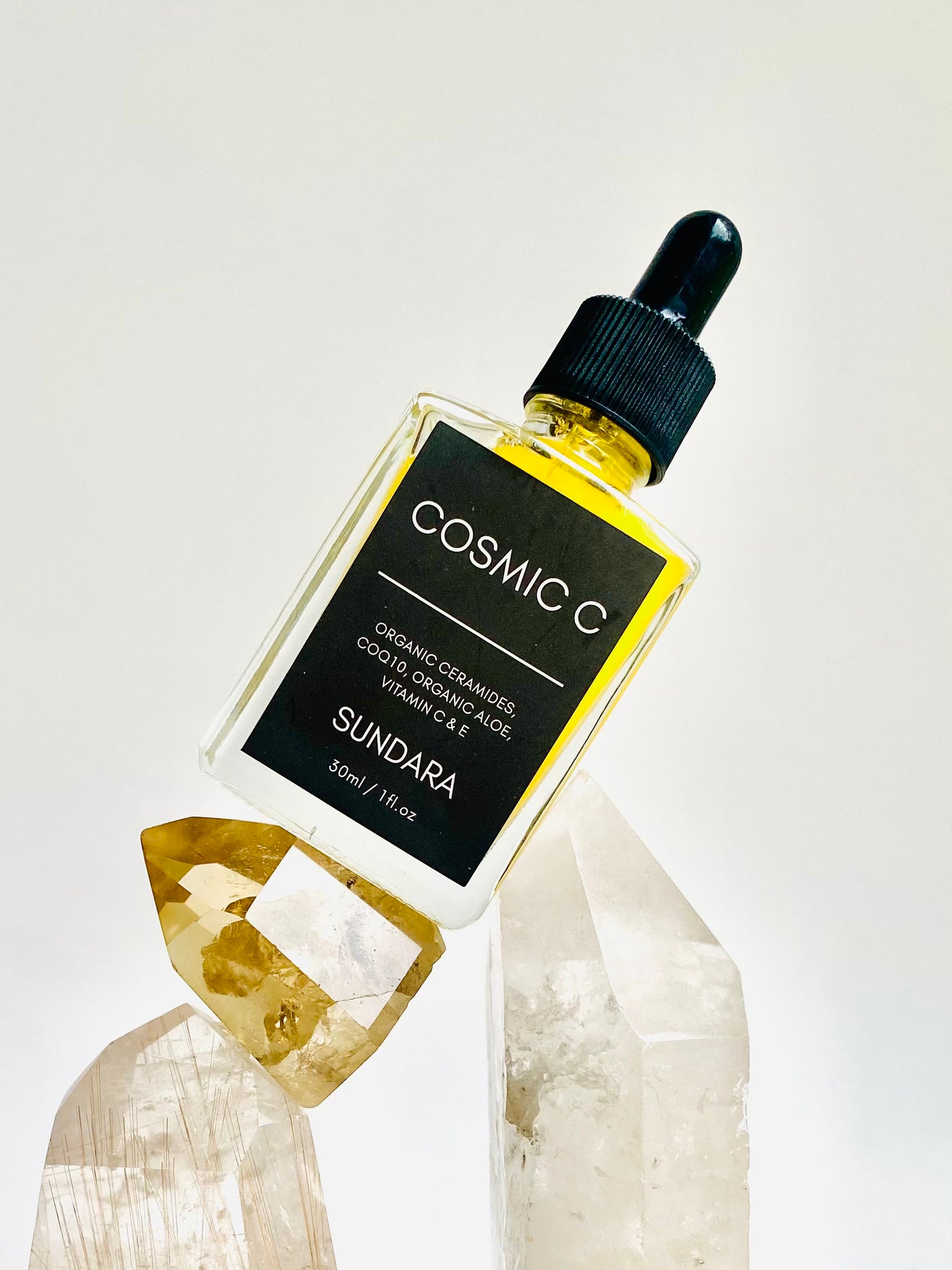 Soul of Sundara Cosmic C Serum on Quartz Crystal. Organic skincare, Ceramides, CoQ10, Organic Aloe, Vitamin C, Vitamin E brightening serum for acne and hyperpigmentation. 