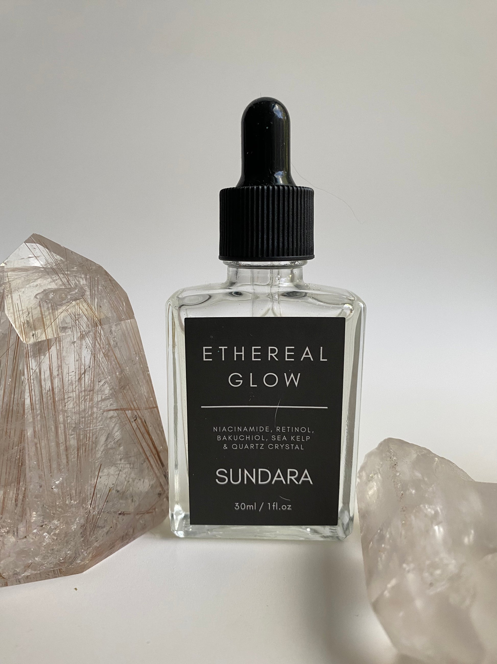 Soul of Sundara Ethereal Glow serum on a quartz crystal. Elasticity improving, collagen boosting serum for aging skin. All natural, scent free, plant based luxury skincare serum.