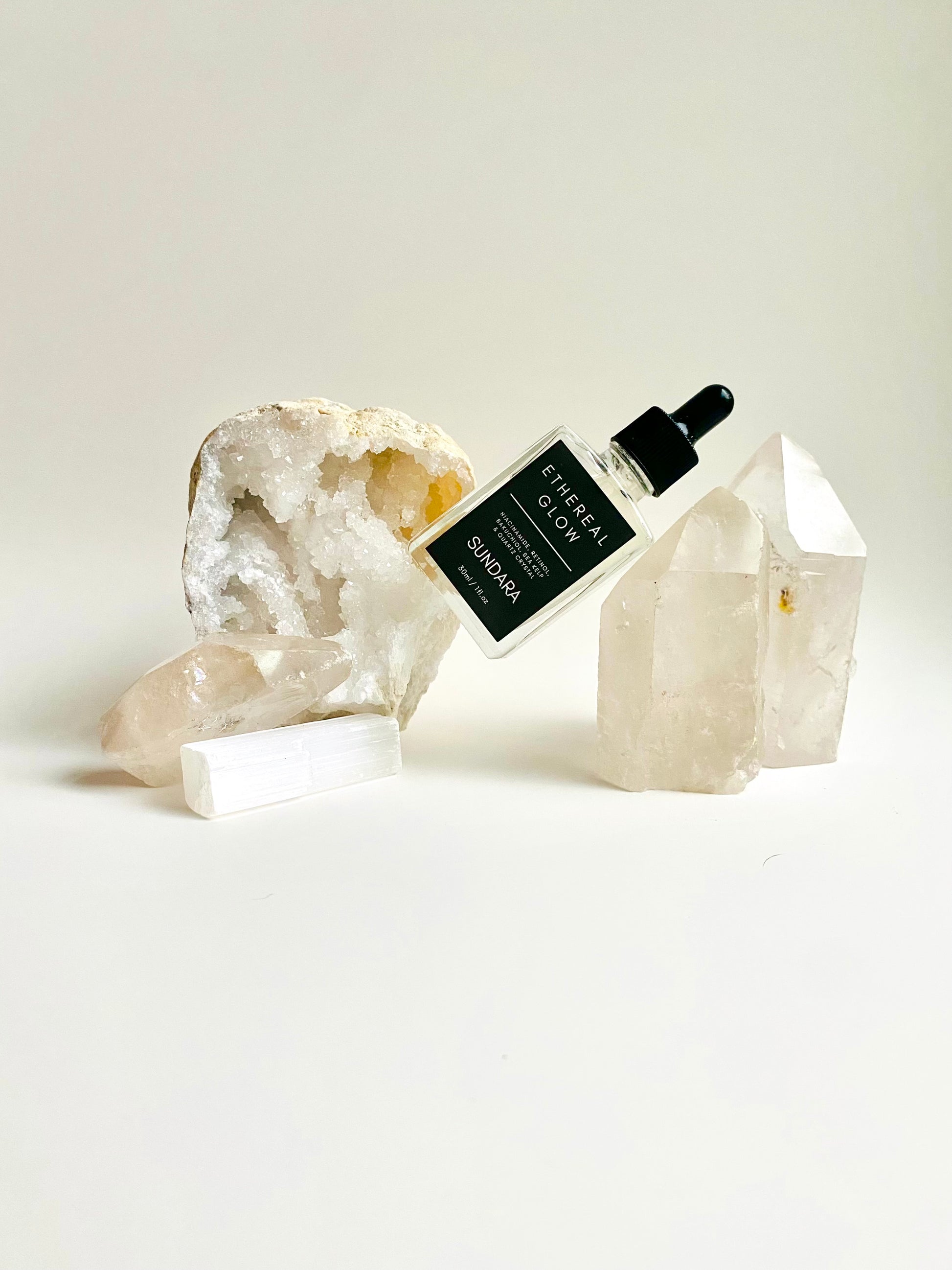 Soul of Sundara Ethereal Glow serum on a quartz crystal. Elasticity improving, collagen boosting serum for aging skin. All natural, scent free, plant based luxury skincare serum.