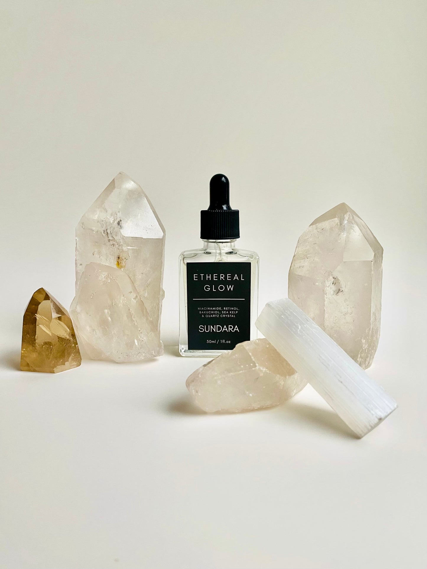 Soul of Sundara Ethereal Glow serum on a quartz crystal. Elasticity improving, collagen boosting serum for aging skin. All natural, scent free, plant based luxury skincare serum.
