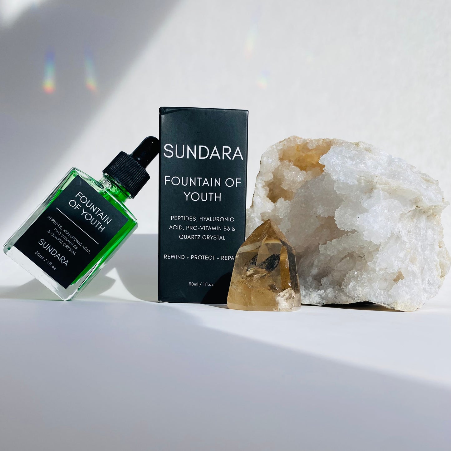 Soul of Sundara Fountain of Youth Serum propped on quartz crystal. Peptides, hyaluronic acid, quartz crystal for aging skin