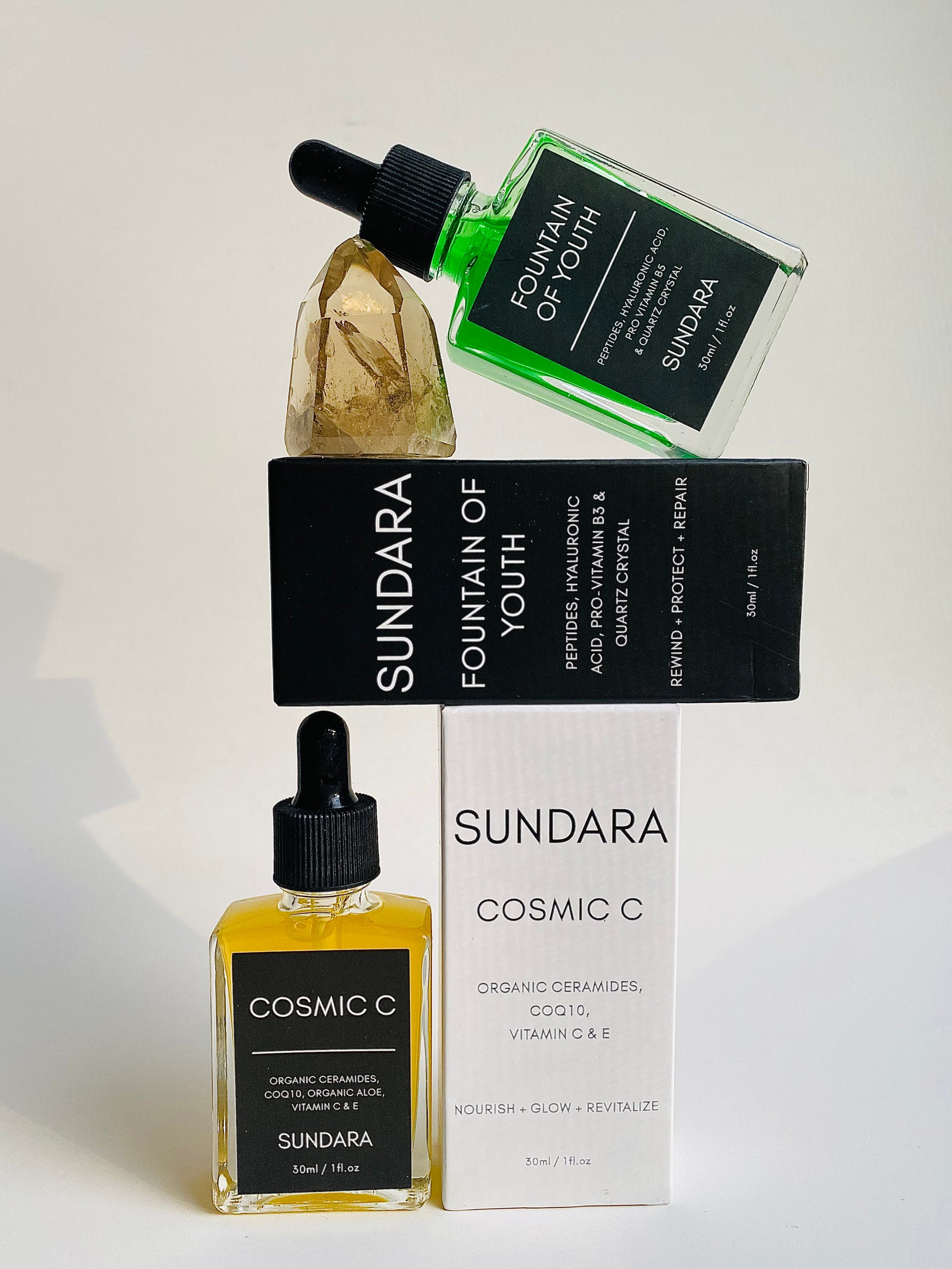Soul of Sundara Fountain of Youth Serum propped on quartz crystal. Peptides, hyaluronic acid, quartz crystal for aging skin