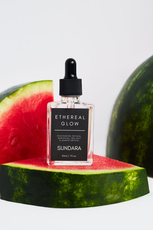 Sundara Ethereal Glow skincare product on a watermelon slice with watermelons in the background.